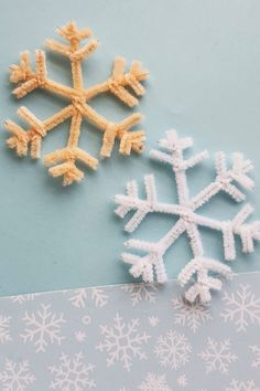 two snowflakes sitting next to each other on a table