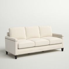 a white couch sitting on top of a hard wood floor