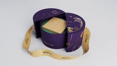 a purple box with a gold ribbon around it