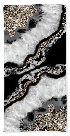 an abstract painting with gold glitters and black marble hand towel featuring the image of two wavy