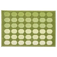 a green rug with white dots on it