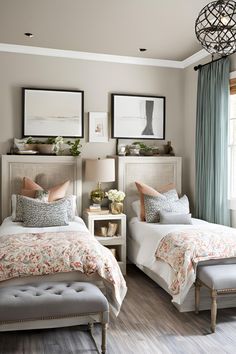 two beds in a bedroom with pictures on the wall above them and a bench at the foot of the bed