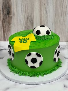 a birthday cake with soccer balls on it