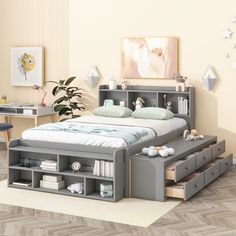 a bedroom with a bed, desk and drawers on the bottom shelf in front of it