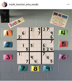 an image of a sudoku board on the wall with numbers and stickers attached to it