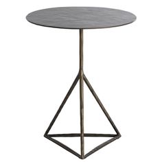 a round table with metal legs and a marble top, on an isolated white background