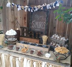 an outdoor dessert table is set up with snacks