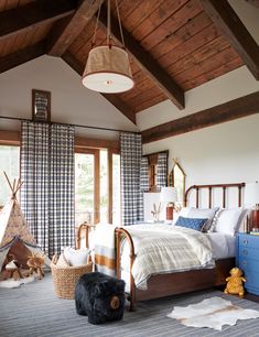 a bed room with a neatly made bed and a teddy bear on the floor next to it