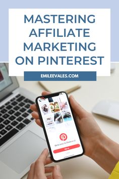 a person holding an iphone in front of a laptop with the text mastering affiliate marketing on pinterest