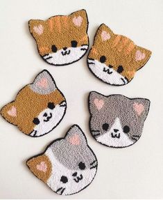 four cat patches are shown on a white surface