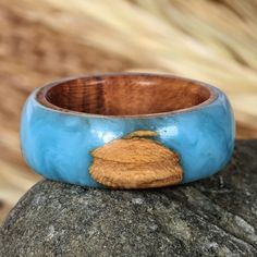 a wooden ring sitting on top of a rock