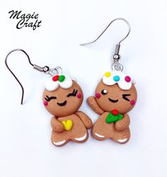 pair of ginger earrings with white frosting and multicolored candies on them