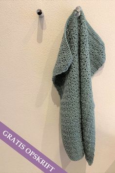 a coat hanging on the wall next to a hook with a button in it that says gratis oskrt