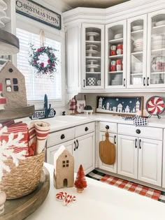 a kitchen decorated for christmas with red, white and blue decor