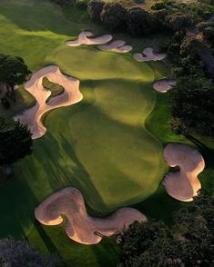 an aerial view of a golf course at sunset