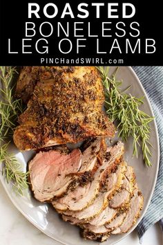 roasted boneless leg of lamb on a plate with rosemary garnish and text overlay