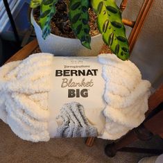 a towel sitting on top of a table next to a potted plant