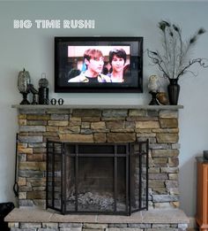 the television is on above the fireplace in the living room, and it's time to decorate mantel with tv above it