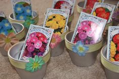 small tins filled with flowers sitting on top of a floor next to each other