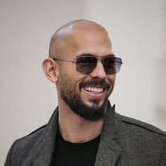 a man with a bald head wearing sunglasses