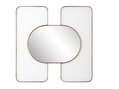 a white mirror with a gold frame on the wall next to an object that is shaped like a rectangle