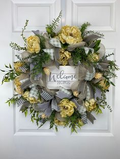 a welcome home wreath with yellow flowers and greenery