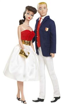 a man and woman doll standing next to each other