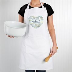 a woman wearing an apron holding a white bowl