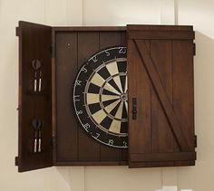 a dart board sitting on top of a wooden cabinet