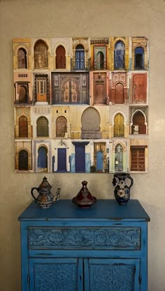 a blue cabinet sitting in front of a wall with pictures on it's side