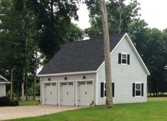 two garages in front of a white house