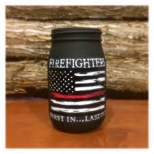 a black firefighter canister sitting on top of a wooden table next to a log