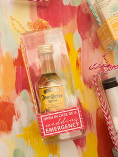 the contents of an emergency kit are displayed on a colorful tablecloth with flowers and candles