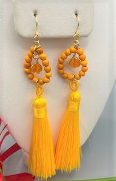 Beautiful long earrings made with a bright yellow tassel one crystal glass bead, 925 sterling silver wire and earrings hook,  and small  orange turquoise beads Made with love and dedication, Feel free to ask for different colors, Orange Tassel Jewelry For Summer, Adjustable Orange Tassel Earrings, Yellow Tassel Drop Earrings With Dangling Beads, Orange Tassel Dangle Earrings, Orange Tassel Earrings, Elegant Yellow Dangle Tassel Earrings, Elegant Yellow Tassel Earrings For Gift, Orange Tassel Drop Earrings With Dangling Beads, Orange Beaded Tassel Earrings As Gift