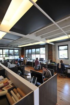 an office with people working on their laptops