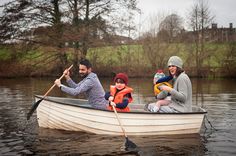 a man, woman and two children in a small boat