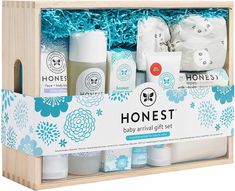 the honest baby gift set is in a wooden box with blue flowers and white packaging