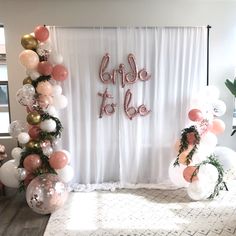 the balloon arch is decorated with pink, white and gold balloons that say bride to be