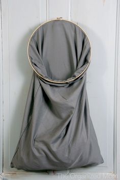 a gray bag hanging on a white door