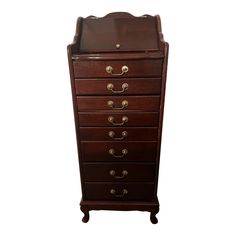 a tall wooden dresser with drawers and brass handles