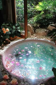 an outdoor hot tub surrounded by plants and flowers