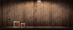 an empty stage with two trash cans and a light on the wall above it, in front of a wooden paneled wall