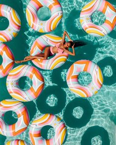 a woman floating on inflatable rings in the water