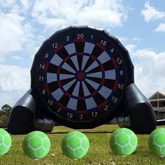 an inflatable dart and four balls on the ground