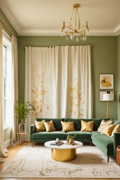 a living room with green couches and white curtains on the windowsill, gold accents