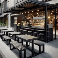 an outdoor restaurant with tables and benches in front of the counter, along with lights hanging from the ceiling