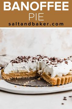 a pie with whipped cream and chocolate sprinkles is on a white plate