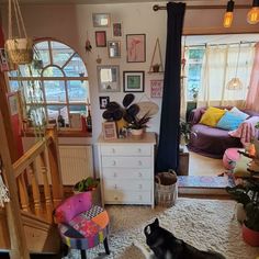 a living room filled with lots of furniture and decor on top of a white rug