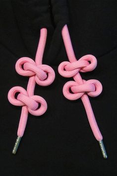 two pink cords connected to each other on a black shirt