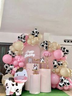 a cow themed birthday party with balloons and decorations